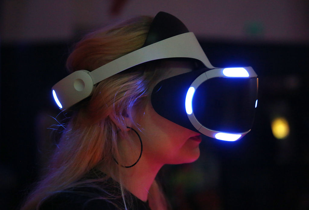 Adrianne Thompson uses a virtual reality headset to play Beat Saber